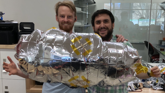Mitch and George Knight (left) pose with an early autonomous blimp prototype.